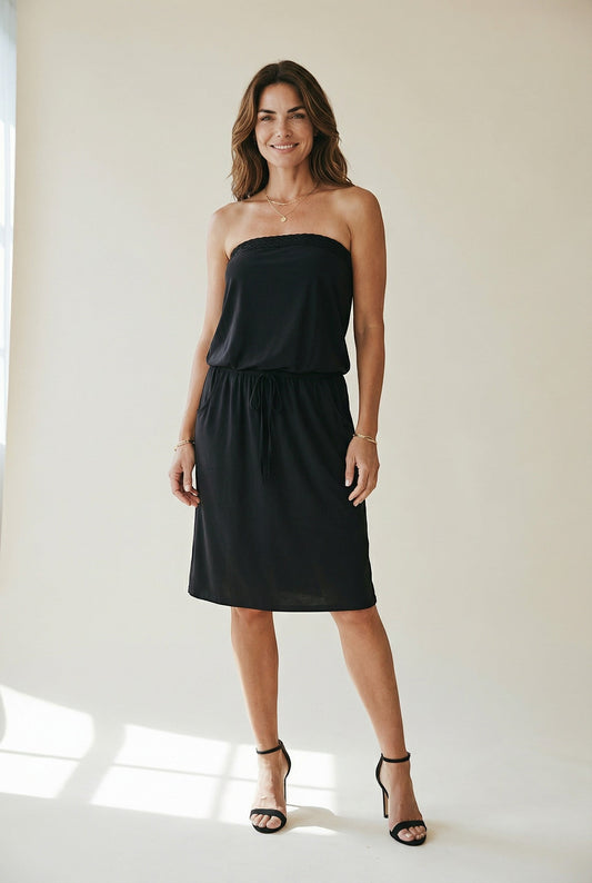 Osanna Creazione black strapless midi dress with cinched waist and pockets, featuring a blousant top and flared skirt.