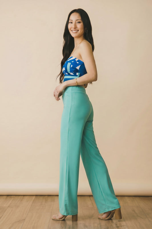 Osanna Creazione fluid teal wide-leg pants with elasticated waist, worn by a model.