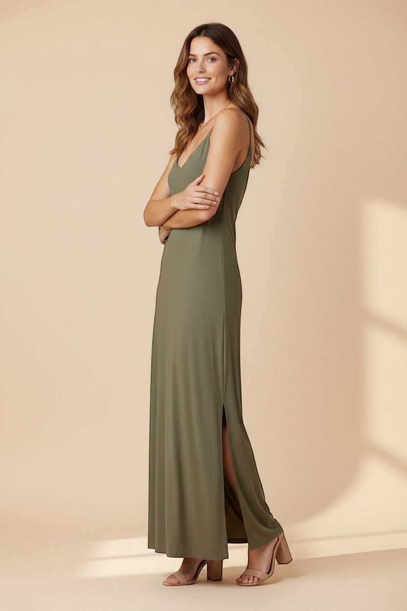 Osanna Creazione olive green maxi dress with thin straps, V-neck, and side slit. Model wears gold jewelry.