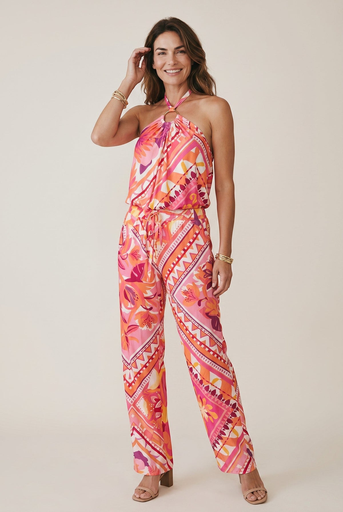 Osanna Creazione pink and orange floral print halter neck wide leg jumpsuit with ring detail and tie waist.