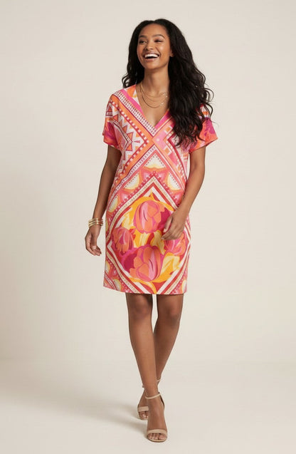 Osanna Creazione Abi short straight dress with V-neck, short sleeves, and a vibrant pink, orange, and yellow floral and geometric print. Includes a matching belt.