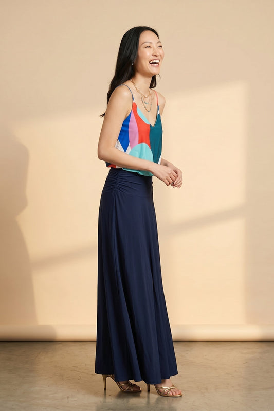 Osanna Creazione women's camisole top with a colourful abstract print and thin straps, paired with a navy ruched maxi skirt.