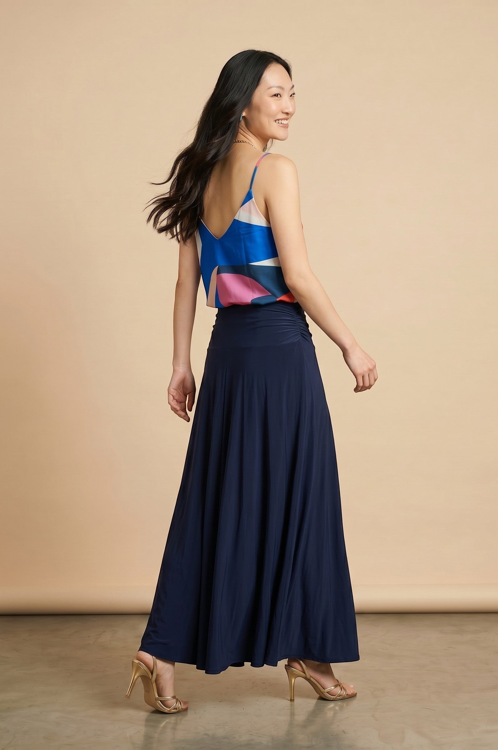 Osanna Creazione abstract print camisole with thin straps and V-neck, paired with a navy blue maxi skirt.