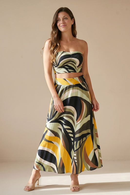 Osanna Creazione women's flowing maxi skirt in abstract print with green, yellow, black, and brown. High waist, A-line cut, and pockets.