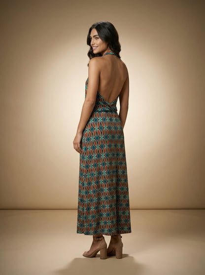 Osanna Creazione Batta long halter neck dress with a deep open back and a flowing draped neckline. Features a geometric print in teal and brown.