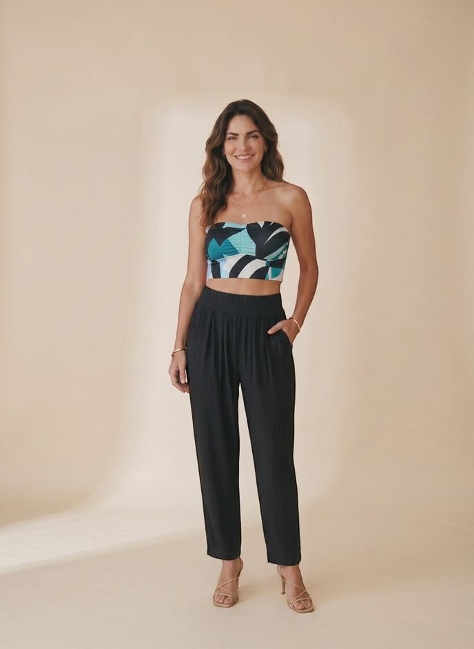 Osanna Creazione black fluid wide-leg trousers with high waist and side pockets, worn by a model.