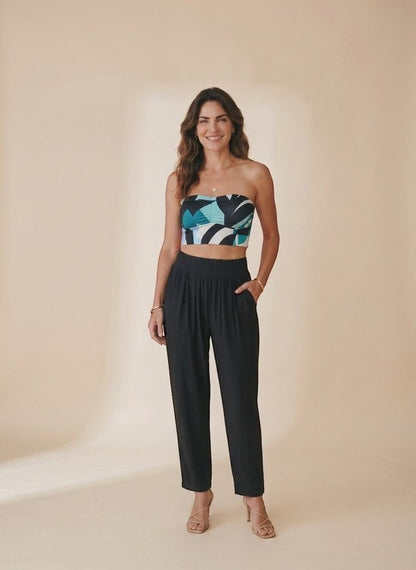 Osanna Creazione black fluid wide-leg trousers with high waist and side pockets, worn by a model.
