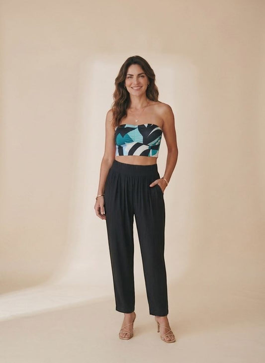 Osanna Creazione black fluid wide-leg trousers with high waist and side pockets, worn by a model.