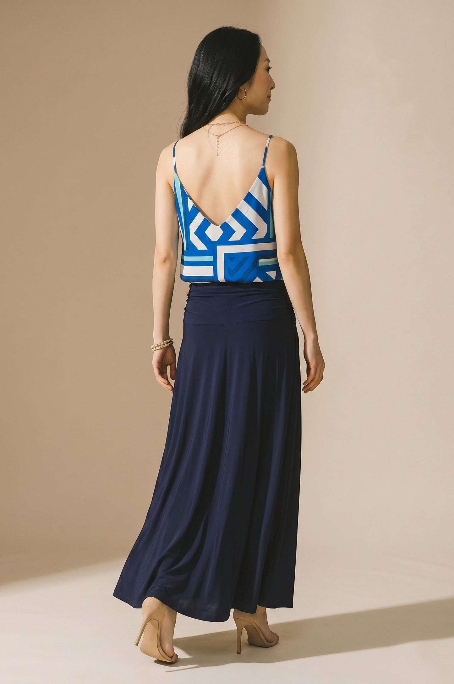 Osanna Creazione blue geometric print camisole with thin straps and deep V-neck back, paired with a navy maxi skirt.