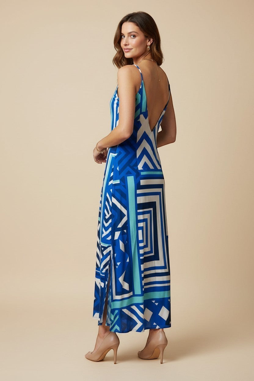 Osanna Creazione blue and white geometric print maxi dress with thin straps and a plunging back. Side slits reveal legs.