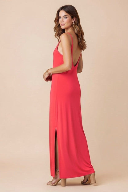 Osanna Creazione coral red maxi dress with thin straps, V-neck, low back, and side slit. Model is wearing size one size.