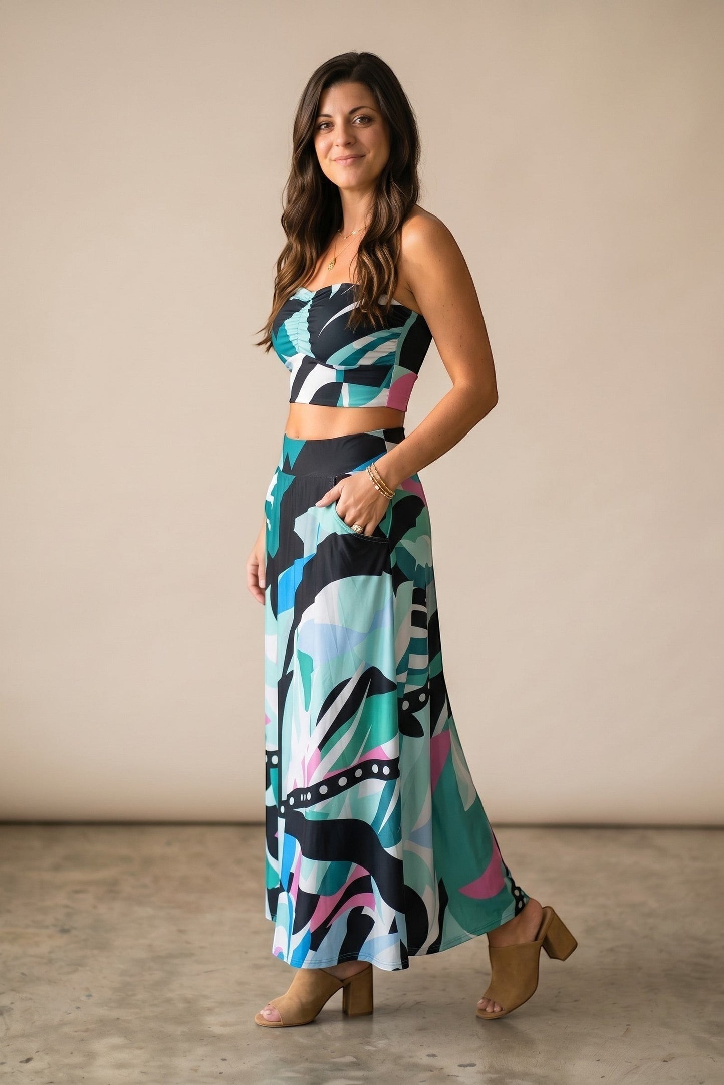 Osanna Creazione women's long flowy skirt with abstract print in teal, black, pink, and blue. Features pockets and a high waist.