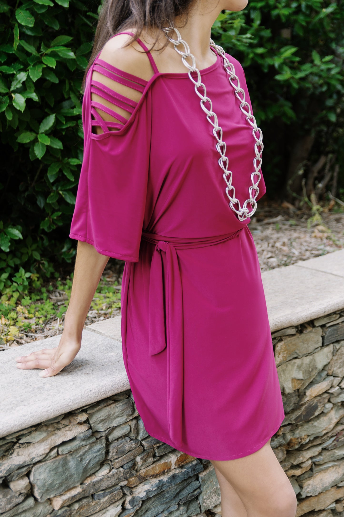 Osanna Creazione Alzira short magenta dress with mid-sleeves, tie belt, and strappy cold-shoulder detail.