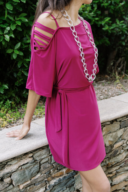 Osanna Creazione Alzira short magenta dress with mid-sleeves, tie belt, and strappy cold-shoulder detail.