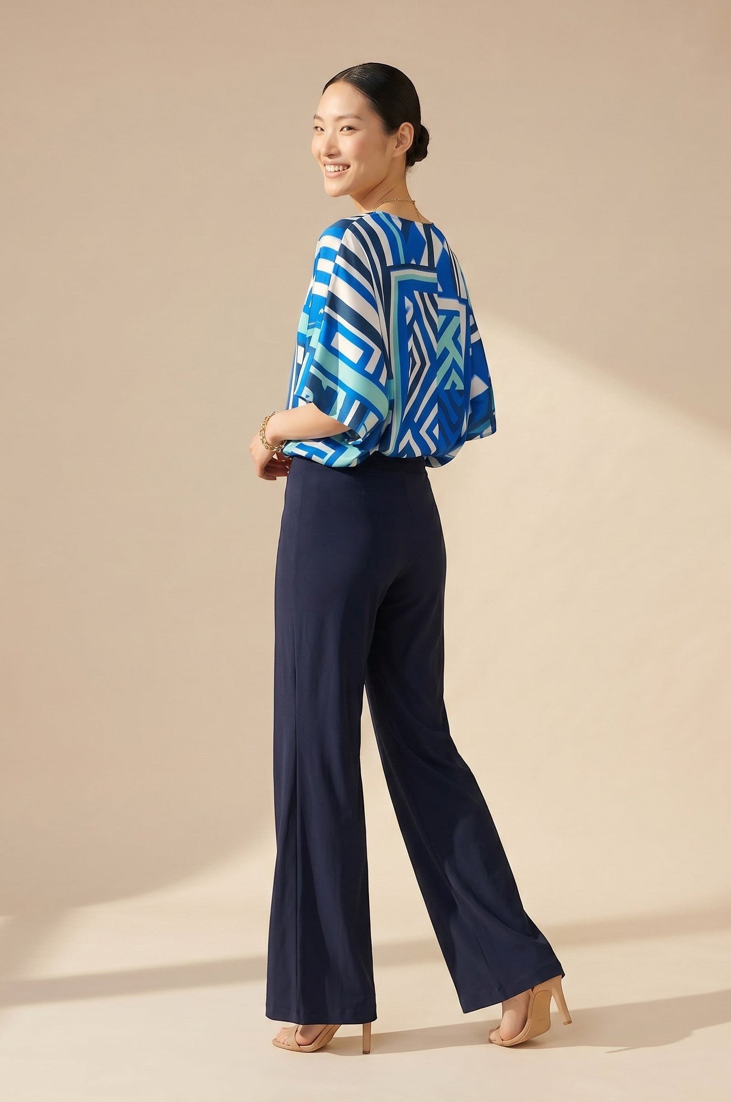 Osanna Creazione navy blue fluid wide-leg trousers with elasticated waist, worn by a model.