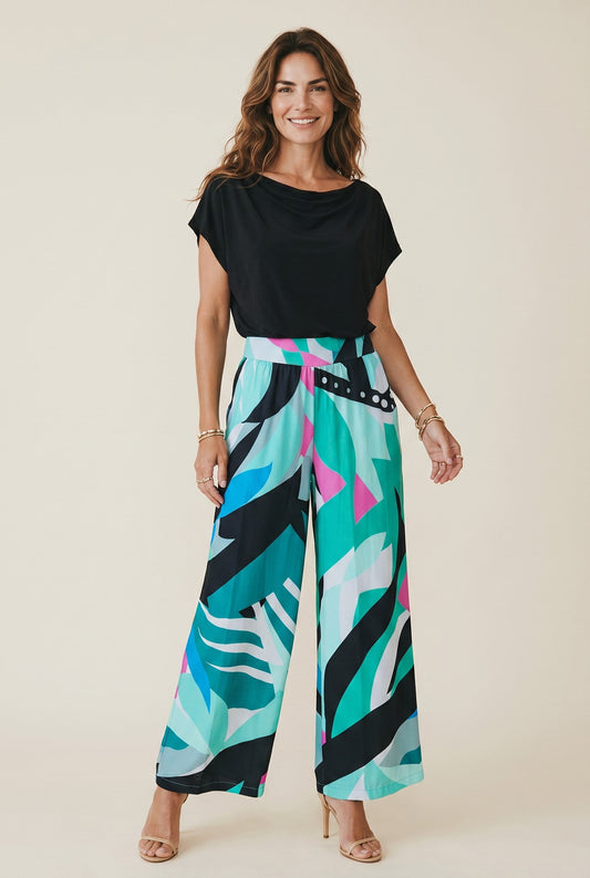 Osanna Creazione Pantalon ample fluide Camila, imprimé abstrait turquoise, rose et noir, coupe large, taille haute, poches latérales.
