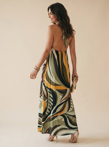 Osanna Creazione robe longue Jilo dos nu, imprimé abstrait kaki, jaune et bleu marine, lien à nouer au cou, anneau doré.