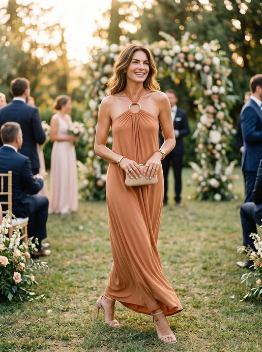 Osanna Creazione robe longue Jilo orange brûlé, dos nu, lien à nouer au cou avec anneau doré, matière fluide. Idéal pour mariage, cérémonie, baptême. 