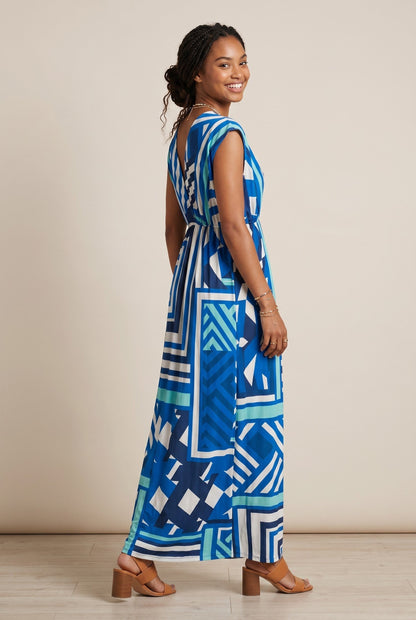 Robe longue empire Baleate Osanna Creazione bleue et blanche à motif géométrique, col V, coupe fluide.