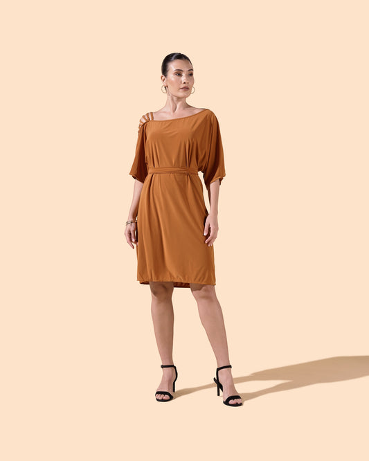 Osanna Creazione Alzira short dress in rust orange with mid-sleeves, belted waist, and strappy shoulder detail. Model wears black heels.