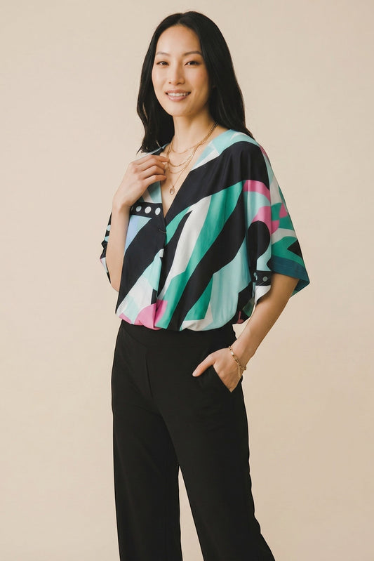 Top fluide col V Osanna Creazione avec imprimé géométrique multicolore, manches larges et coupe ample.