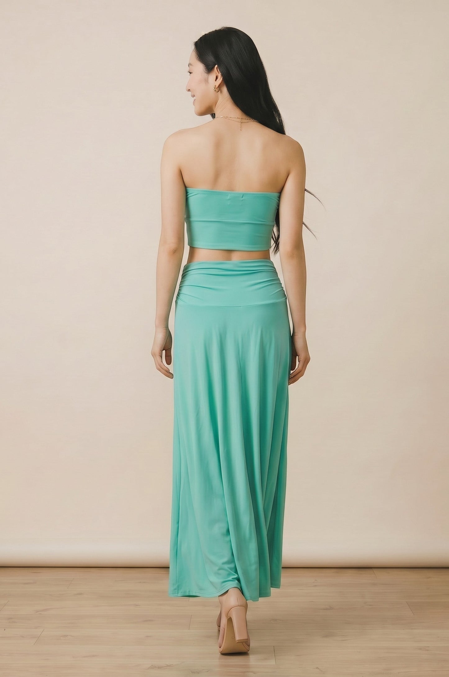 Osanna Creazione turquoise long fluid skirt with ruched waistband, worn by a model from behind.