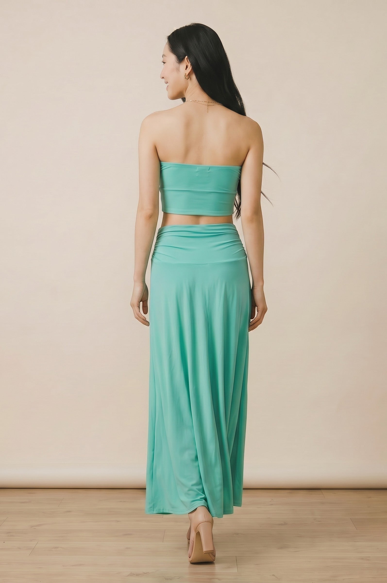 Osanna Creazione turquoise long fluid skirt with ruched waistband, worn by a model from behind.